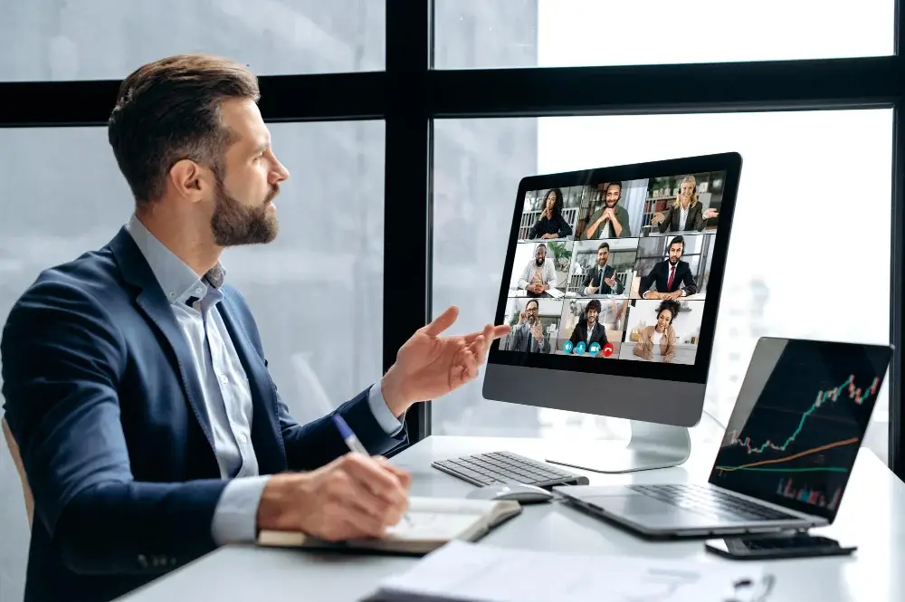 clever successful businessman conducts brainstorm company boss stock investor having conversation with group multiracial people by video conference discuss investments stock marketrisks